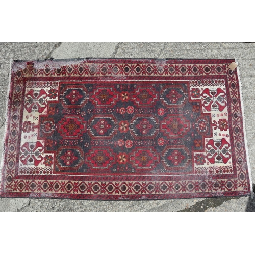 597 - A Kazak style rug with three medallions, 72