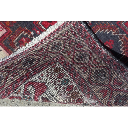 597 - A Kazak style rug with three medallions, 72