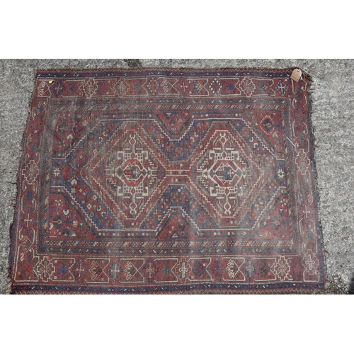 597 - A Kazak style rug with three medallions, 72