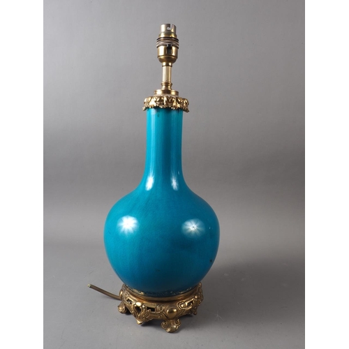 69 - A Chinese turquoise glazed bottle vase with gilt metal mounts (now converted as a table lamp), 17 1/... 