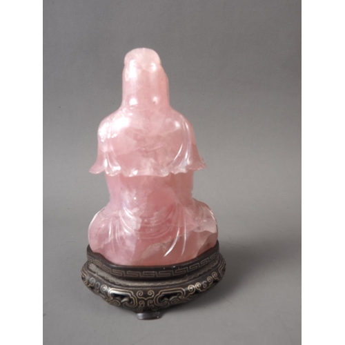 85 - A Chinese rose quartz Buddha, on carved and silver inlaid wooden base, 4 3/4