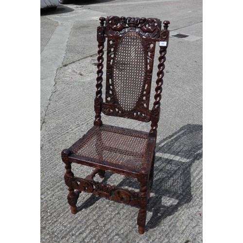 409 - A late 17th century carved walnut side chair with oval cane back panel, cane seat and cherubim crown... 