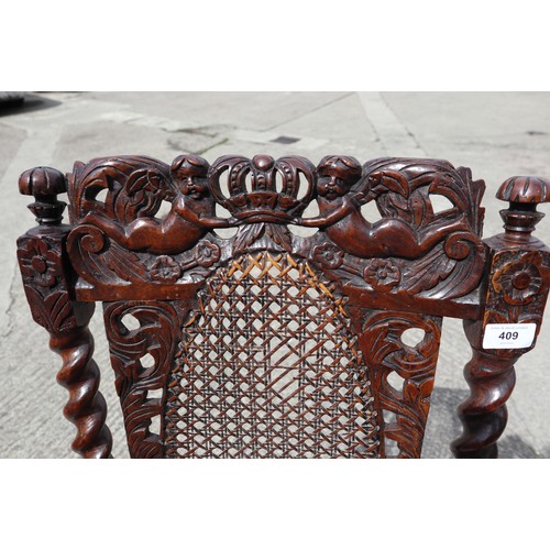 409 - A late 17th century carved walnut side chair with oval cane back panel, cane seat and cherubim crown... 