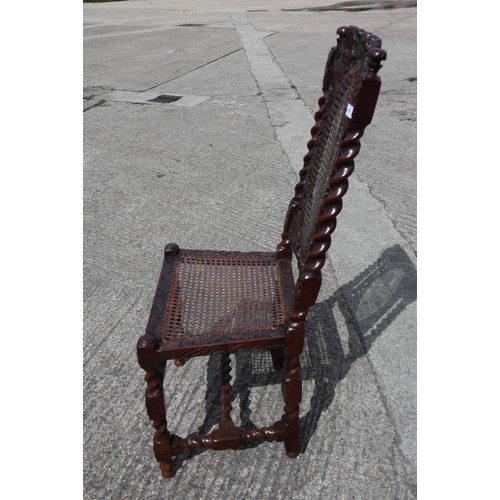 409 - A late 17th century carved walnut side chair with oval cane back panel, cane seat and cherubim crown... 