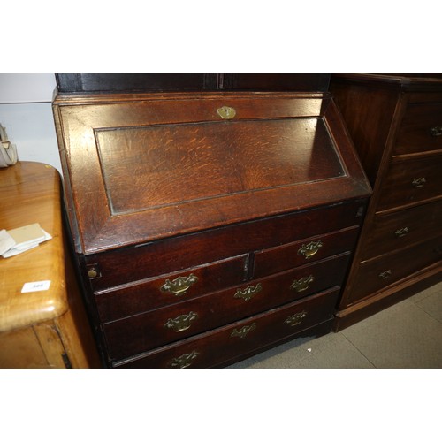 415 - An 18th century oak bureau bookcase, the upper section enclosed panelled doors over fitted writing c... 