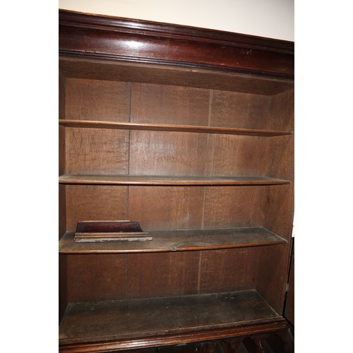 415 - An 18th century oak bureau bookcase, the upper section enclosed panelled doors over fitted writing c... 