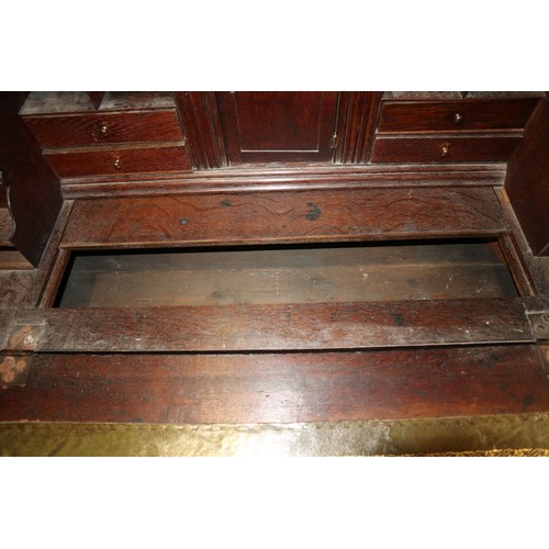 415 - An 18th century oak bureau bookcase, the upper section enclosed panelled doors over fitted writing c... 