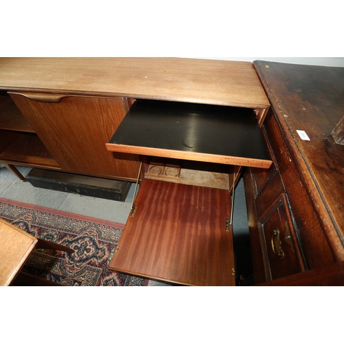 554 - A 1960s McIntosh sideboard, fitted three drawers and three doors enclosed shelves, cellarette and a ... 