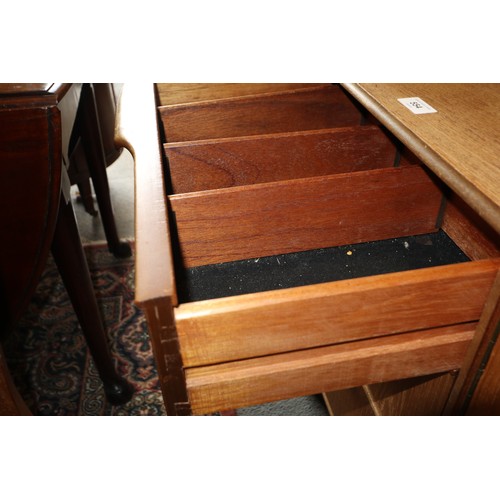 554 - A 1960s McIntosh sideboard, fitted three drawers and three doors enclosed shelves, cellarette and a ... 