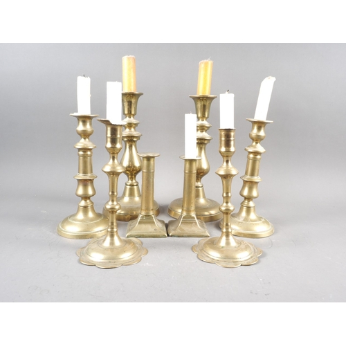 117 - A pair of 18th century brass petal base candlesticks, and three other pairs of brass candlesticks