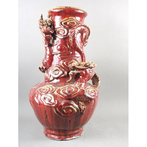 62 - A Chinese sang de boeuf glazed vase with relief dragon and cloud decoration, 22