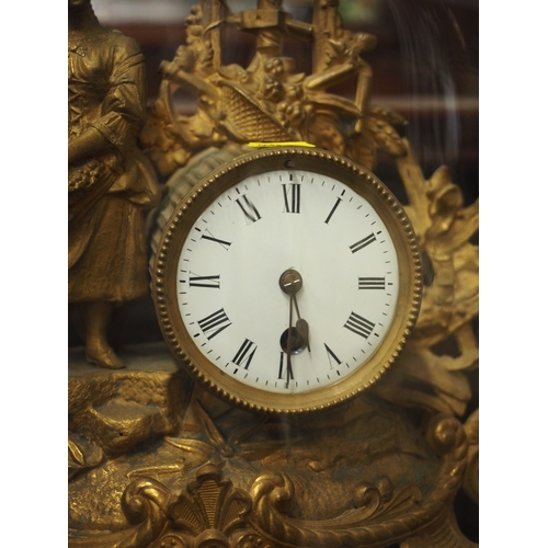 90 - A 19th century French gilt metal mantel clock with white enamelled dial and attendant figure, under ... 