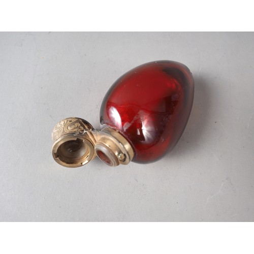 60 - A ruby glass and silver gilt topped scent bottle, 3 1/4