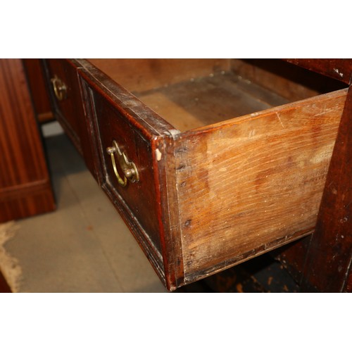 410 - An 18th century fruitwood dresser base, fitted one short and two long fielded panel front drawers, o... 