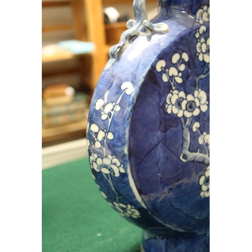 79 - A pair of Chinese blue and white moon flasks with relief dragon handles and prunus decoration, four-... 