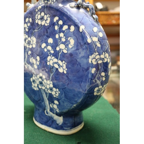 79 - A pair of Chinese blue and white moon flasks with relief dragon handles and prunus decoration, four-... 