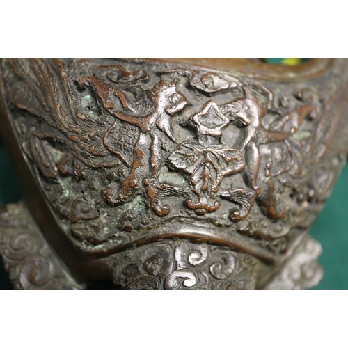 83 - A Chinese bronze censer, decorated clouds, with elephant finial, 10