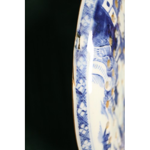 65 - A Chinese export blue and white circular dish drainer with landscape decoration, 13