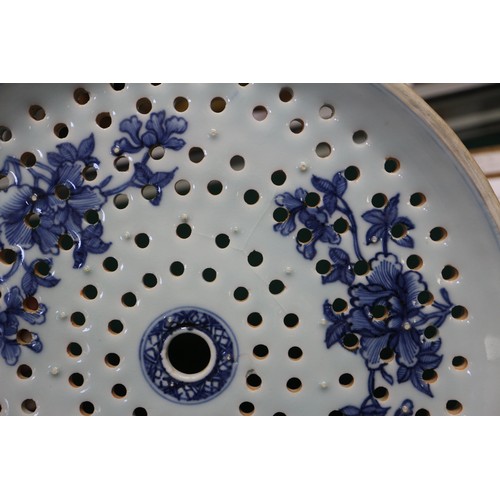 65 - A Chinese export blue and white circular dish drainer with landscape decoration, 13