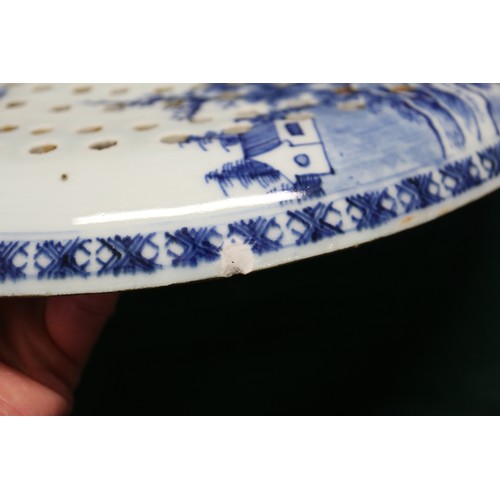 65 - A Chinese export blue and white circular dish drainer with landscape decoration, 13