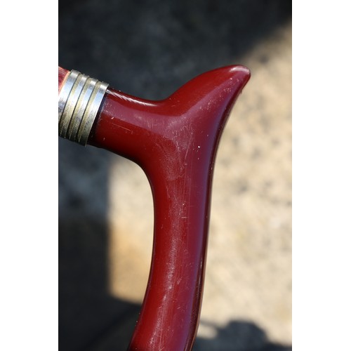 136 - A walking stick with red Bakelite handle, 36 1/4