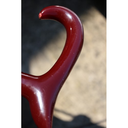 136 - A walking stick with red Bakelite handle, 36 1/4