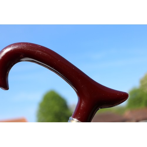 136 - A walking stick with red Bakelite handle, 36 1/4