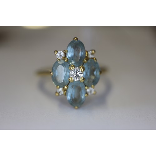 255 - An 18ct gold diamond and aquamarine dress ring, size P, 3.4g