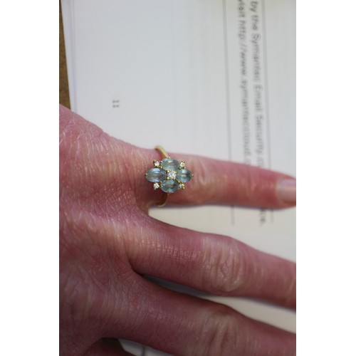 255 - An 18ct gold diamond and aquamarine dress ring, size P, 3.4g