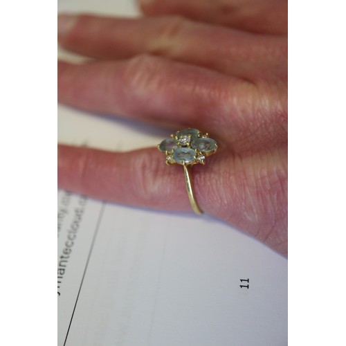 255 - An 18ct gold diamond and aquamarine dress ring, size P, 3.4g