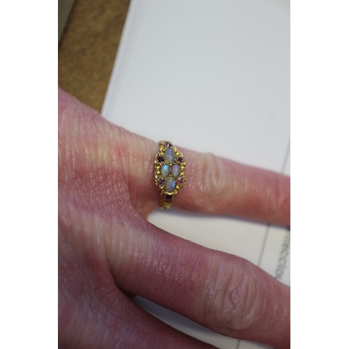 273 - A Victorian yellow metal, opal and ruby dress ring, size L, 1.9g