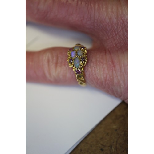 273 - A Victorian yellow metal, opal and ruby dress ring, size L, 1.9g