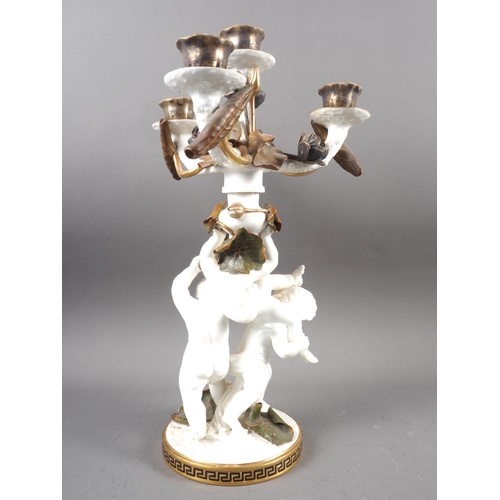 7 - A 19th century Moores three-branch four-light candelabrum of cherub and floral design with gilt bord... 