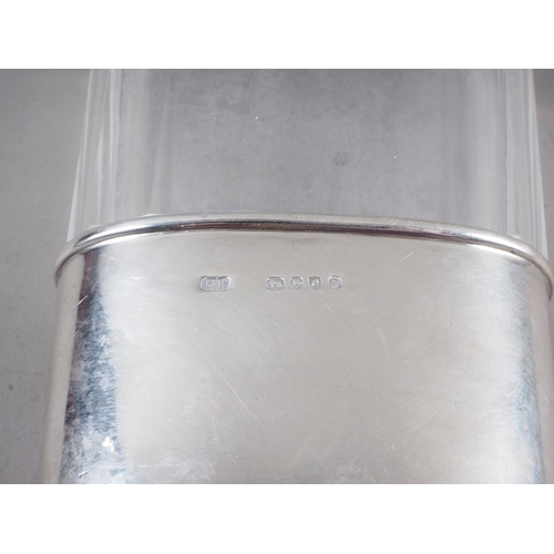 226 - A clear faceted glass hip flask with silver cup and white metal cap, 4 1/2