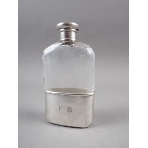 226 - A clear faceted glass hip flask with silver cup and white metal cap, 4 1/2