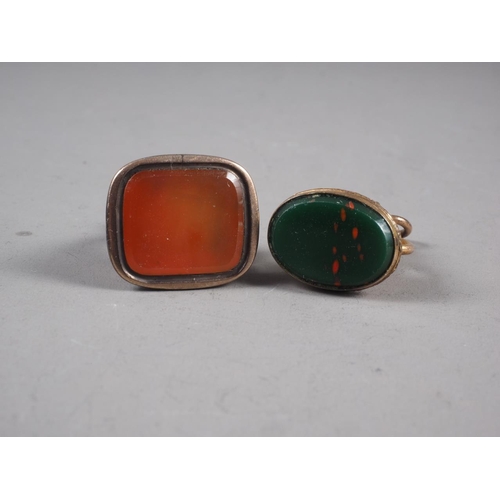 247 - A 19th century gold cased fob seal with carnelian matrix and another similar with bloodstone matrix