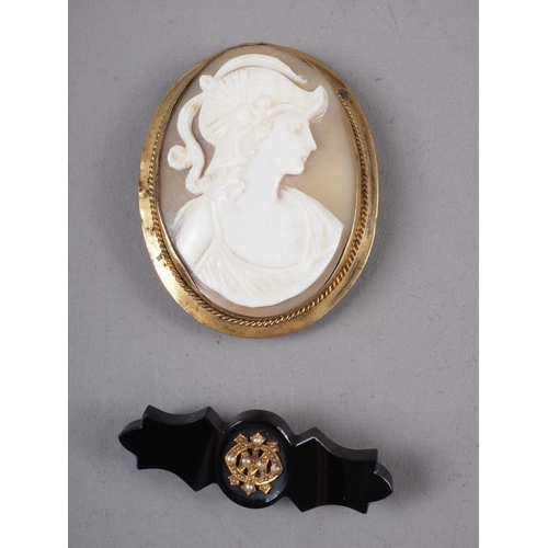 293 - A carved shell cameo, in yellow metal oval brooch mount, and a 19th century jet mourning brooch with... 