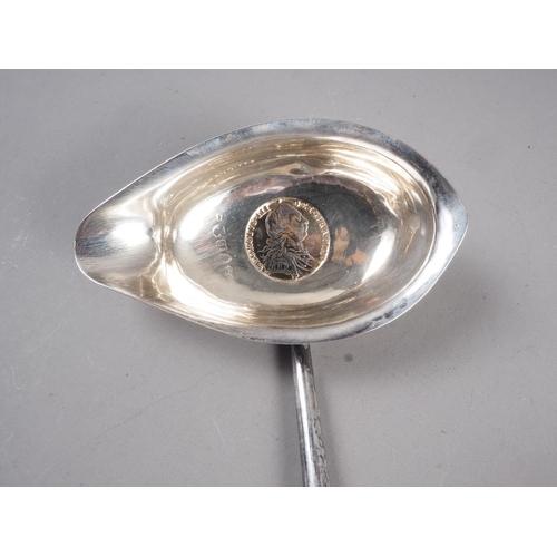 258 - A Georgian silver toddy ladle with twisted whale bone handle, 14 3/4