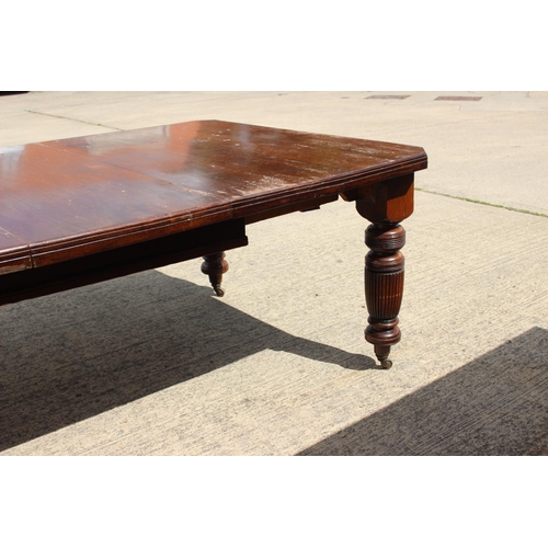 419 - A late 19th century walnut extending dining table with one extra leaf, 75