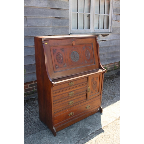 421 - A late Victorian carved walnut fall front bureau with fitted interior over cupboard, three smaller a... 