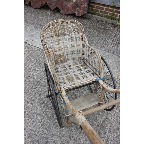 591 - A child's late 19th/early 20th century bamboo, wicker and green painted iron dog cart/pram, 32