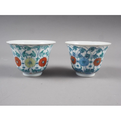 86 - A pair of Chinese teacups with floral and leaf decoration, four-character marks to bases, 3 1/4