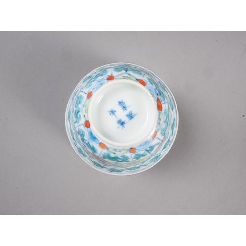 86 - A pair of Chinese teacups with floral and leaf decoration, four-character marks to bases, 3 1/4