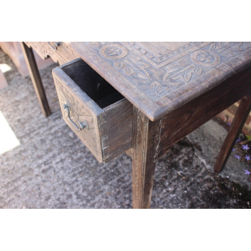 404 - A carved oak lowboy of early 18th century design, fitted two deep and one shallow drawer, on chamfer... 