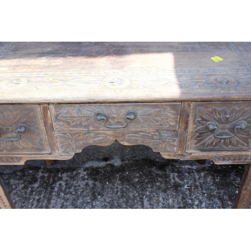 404 - A carved oak lowboy of early 18th century design, fitted two deep and one shallow drawer, on chamfer... 