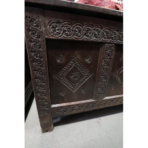 406 - An 18th century carved oak triple panel front coffer with candle box,  lined with newspaper dated 18... 