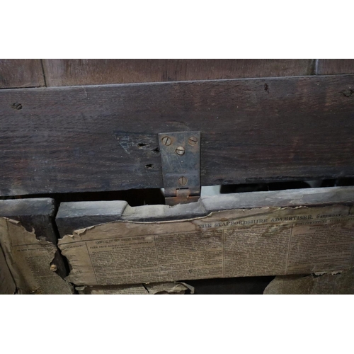 406 - An 18th century carved oak triple panel front coffer with candle box,  lined with newspaper dated 18... 