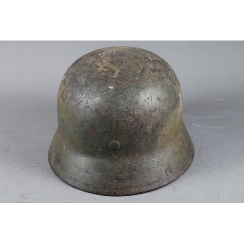 143 - A WWII German helmet with leather lining