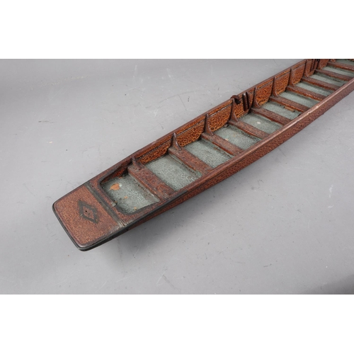 194 - An early 20th century hardwood model punt, Makers label: 