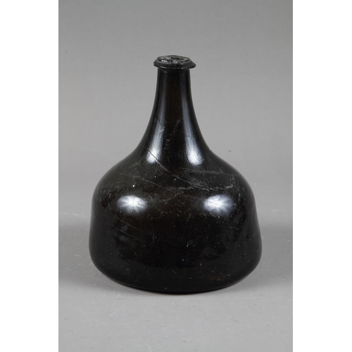 38 - An early 18th century green glass onion wine bottle, 7 1/4